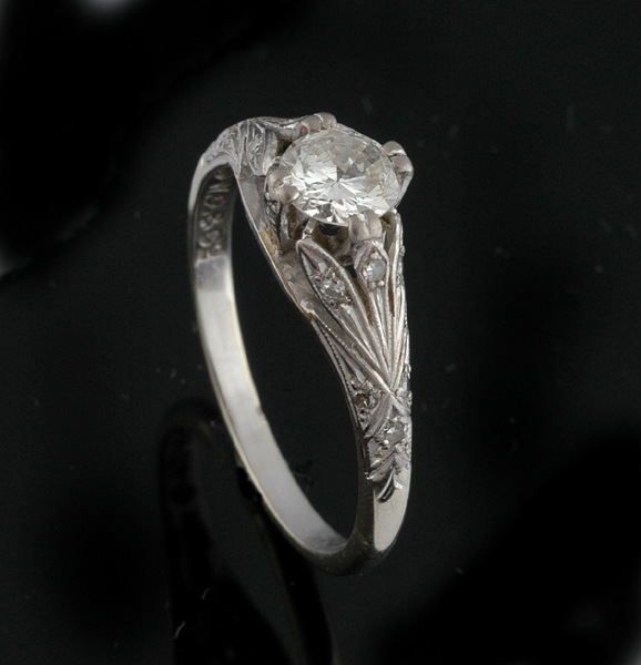 Appraisal: A DIAMOND SOLITAIRE RING The round transitional cut diamond weighing