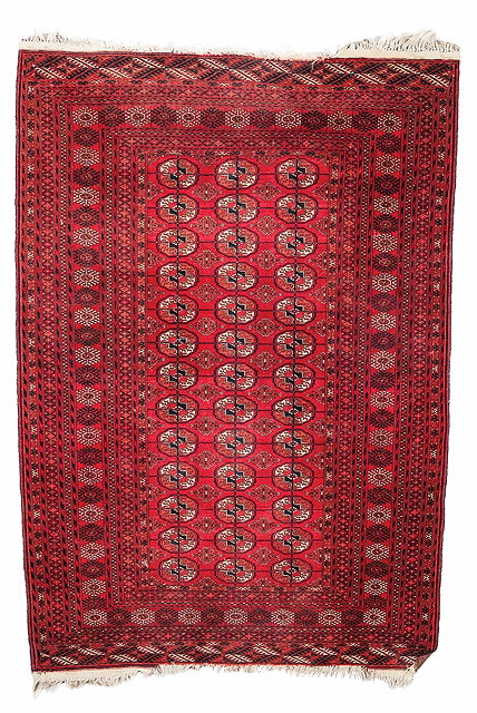 Appraisal: A TEKKE TURKOMAN WINE GROUND RUG with three rows of