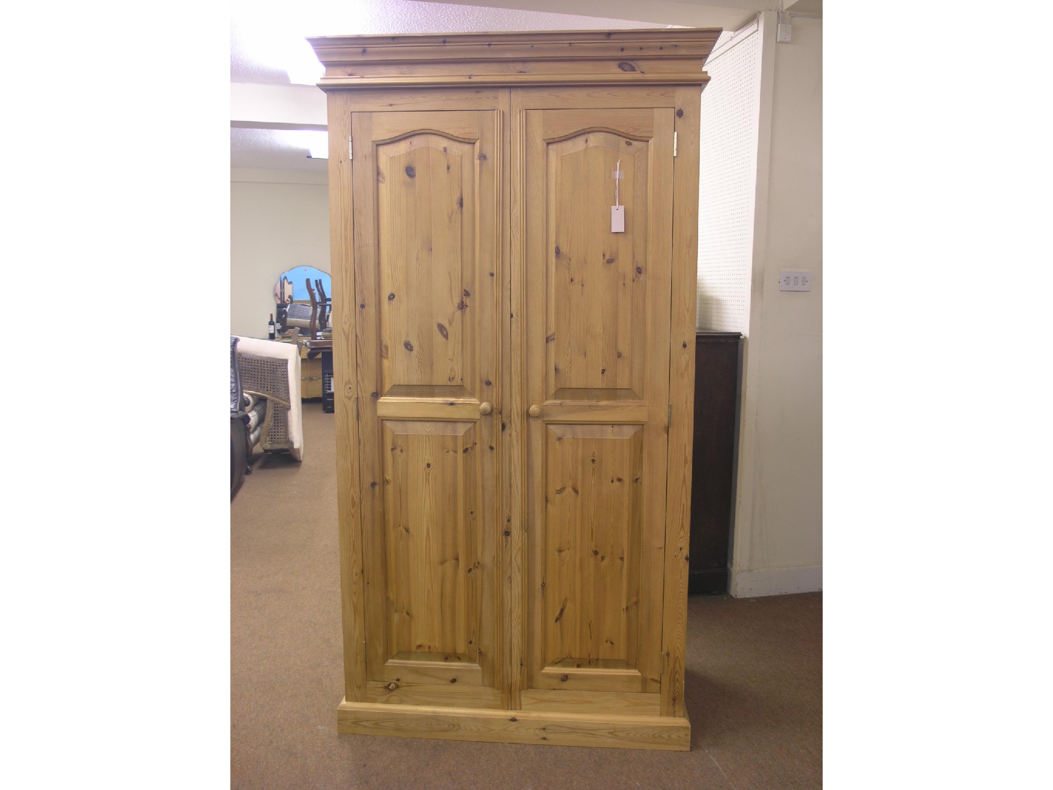 Appraisal: A modern waxed pine wardrobe enclosed by a pair of