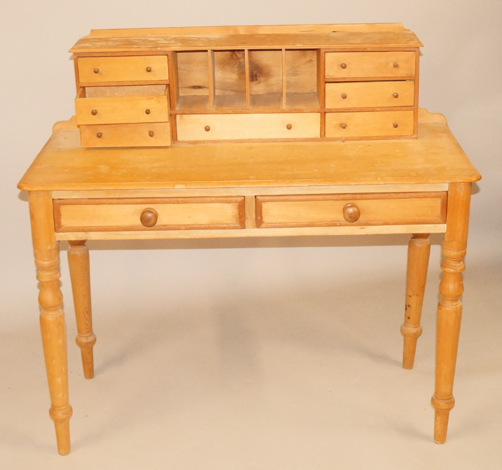 Appraisal: A pine desk the raised back with seven drawers and