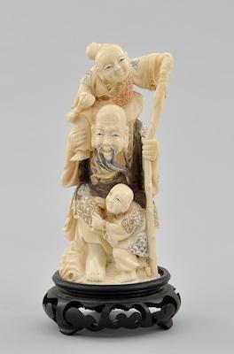 Appraisal: Carved Ivory Elder with Children Charming figural group with fancy