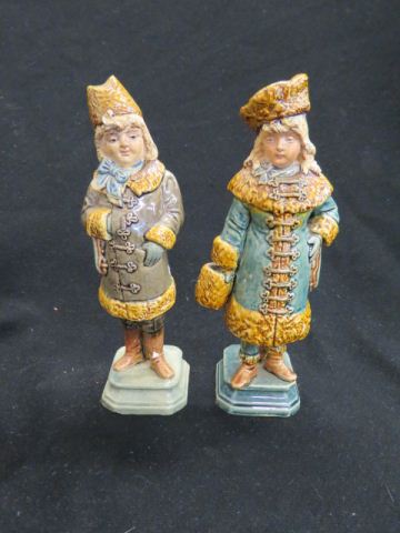 Appraisal: Pair of Majolica Pottery Figurine of Girls in winter coats