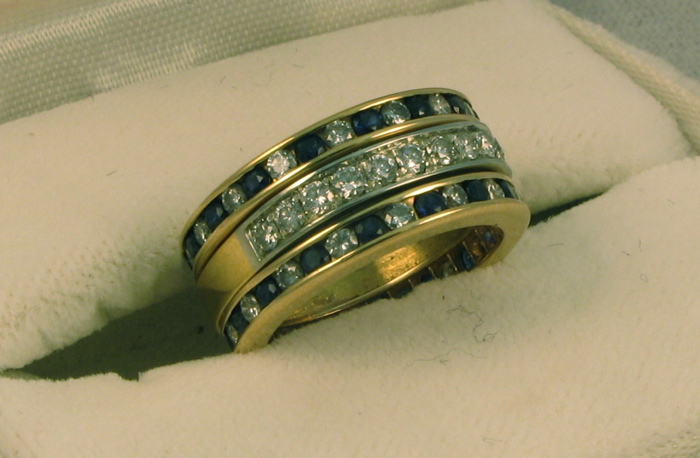 Appraisal: SAPPHIRE DIAMOND AND EIGHTEEN KARAT GOLD RING set with round-cut