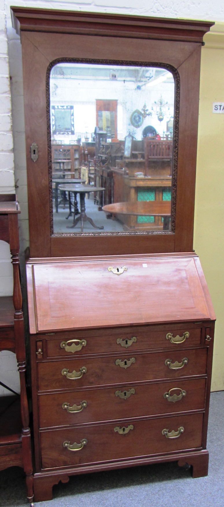 Appraisal: A mid th century mahogany bureau cabinet the single mirrored