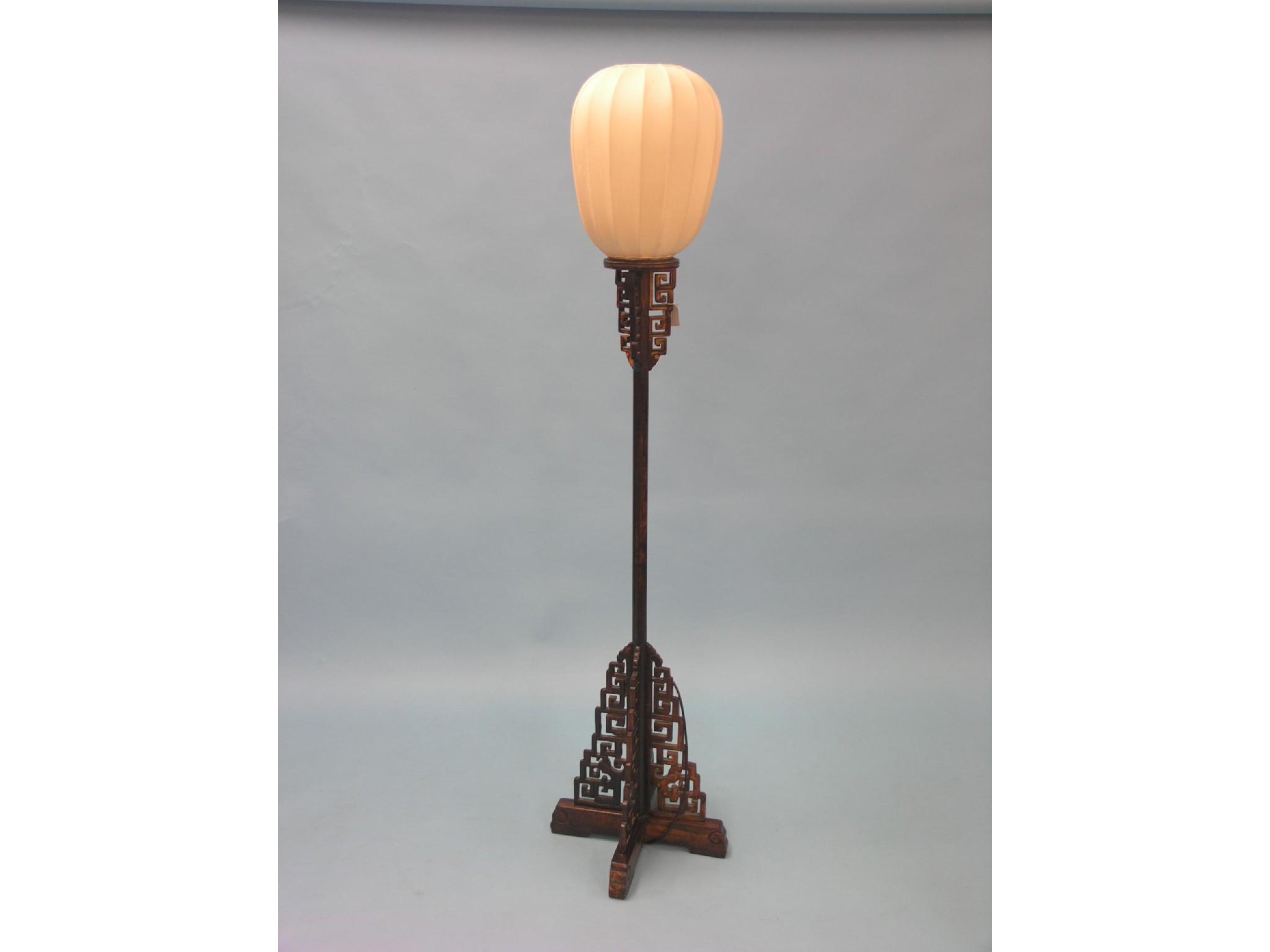 Appraisal: A Chinese hardwood floor lamp with fret-carved detail with shade