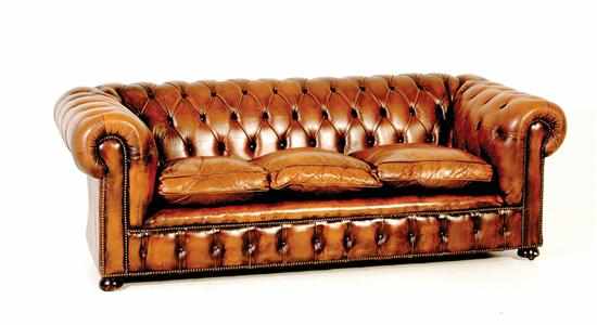 Appraisal: Leather Chesterfield sofa tufted straight back continuing to outscrolled arms