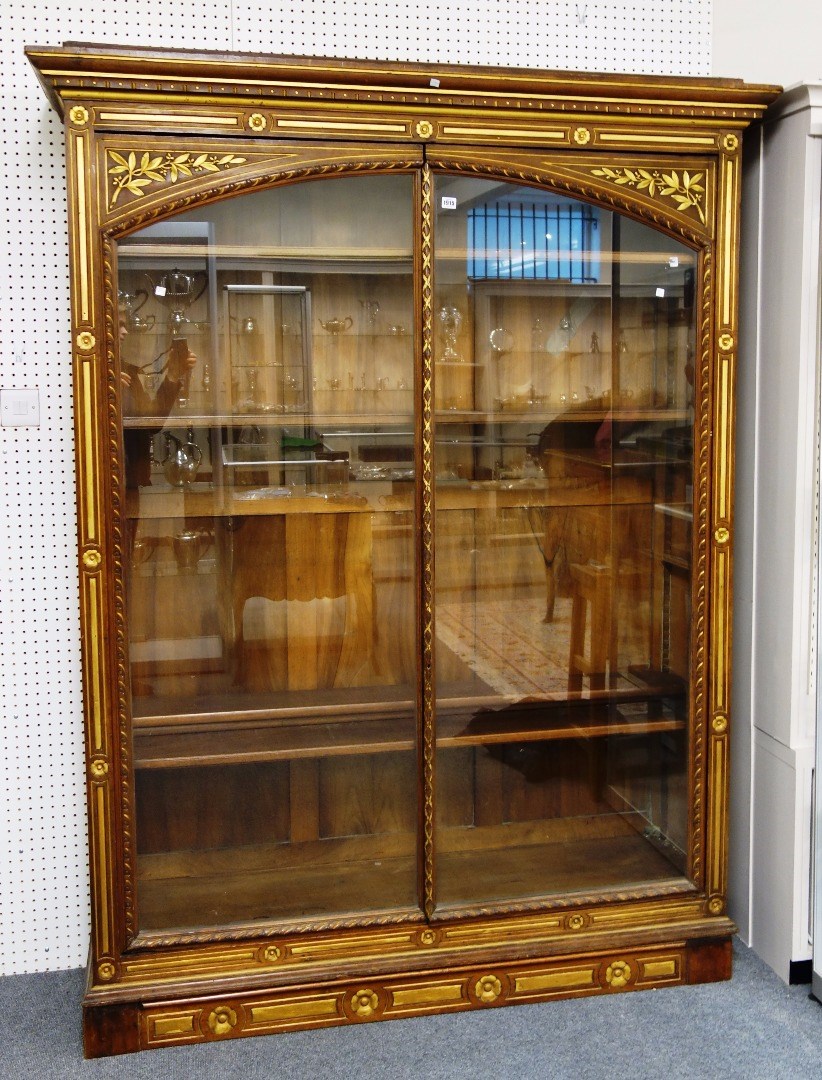 Appraisal: A th century continental parcel gilt walnut floor standing display