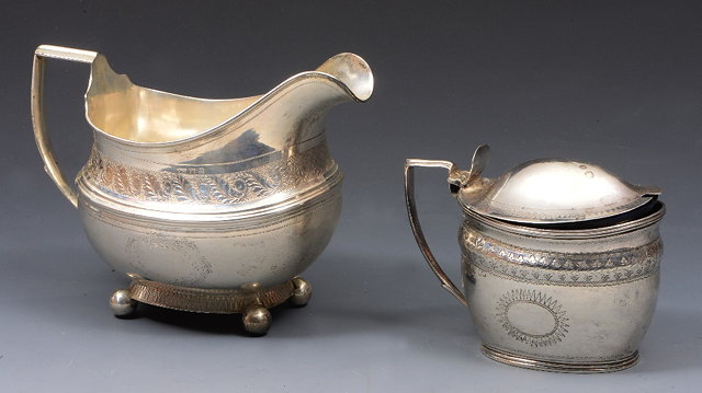 Appraisal: A GEORGIAN SILVER OVAL SHAPED CREAM JUG with engraved foliate