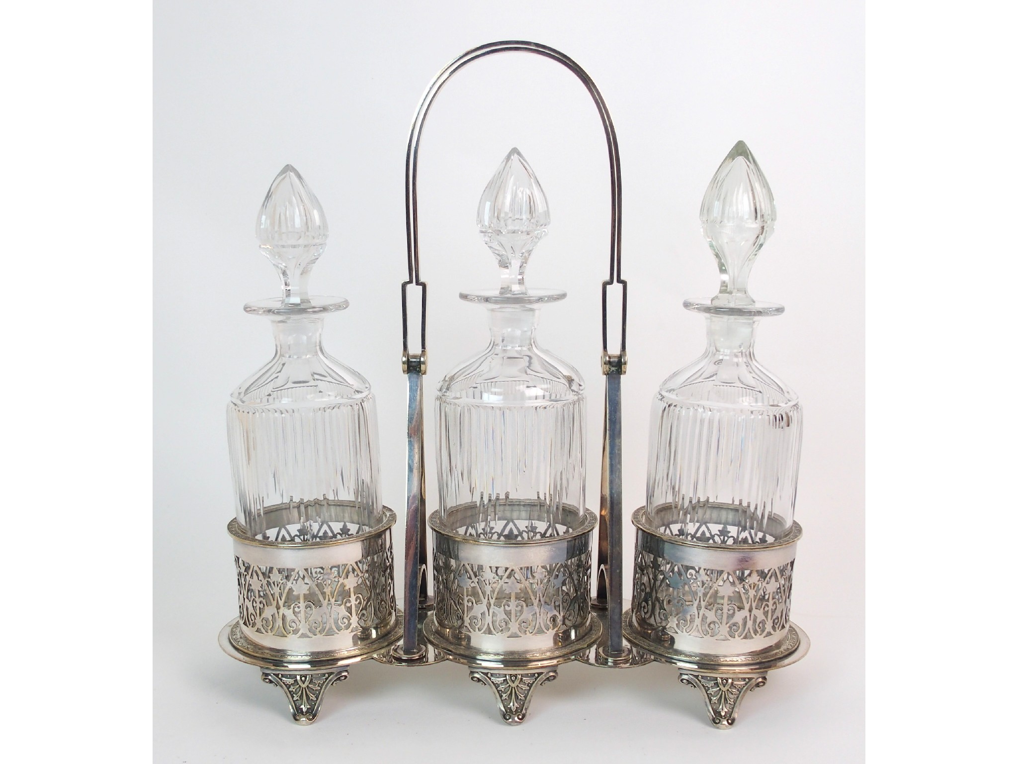 Appraisal: A silver plated -bottle decanter standwith pierced decoration on six