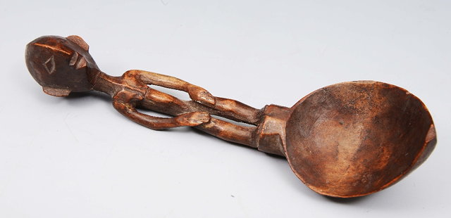 Appraisal: AN AFRICAN CARVED WOODEN SPOON with figural handles cm long