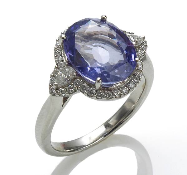 Appraisal: A sapphire and diamond ring centering an oval-shaped sapphire weighing