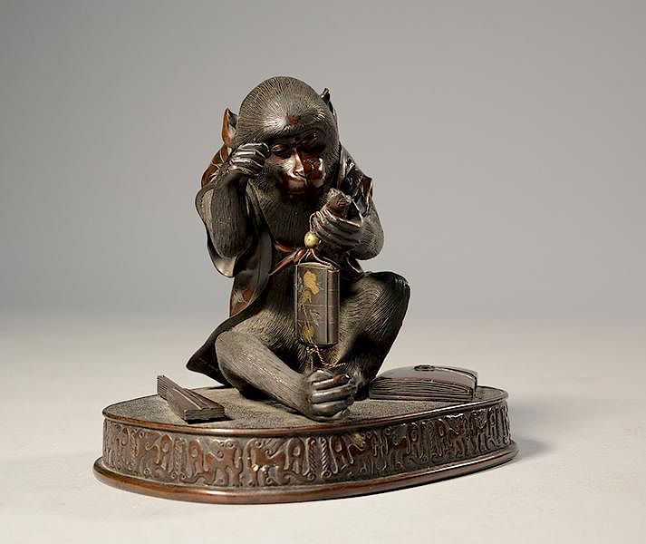 Appraisal: Japanese Meiji period bronze seated monkey inspecting his inro Japanese