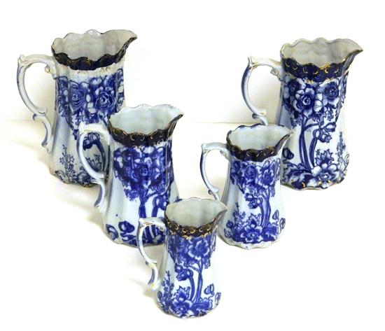 Appraisal: Five flow blue ''Victor'' pattern graudated pitchers with gilt at