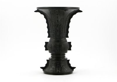 Appraisal: A Chinese bronze gu-shaped beaker vase cast with taotie masks