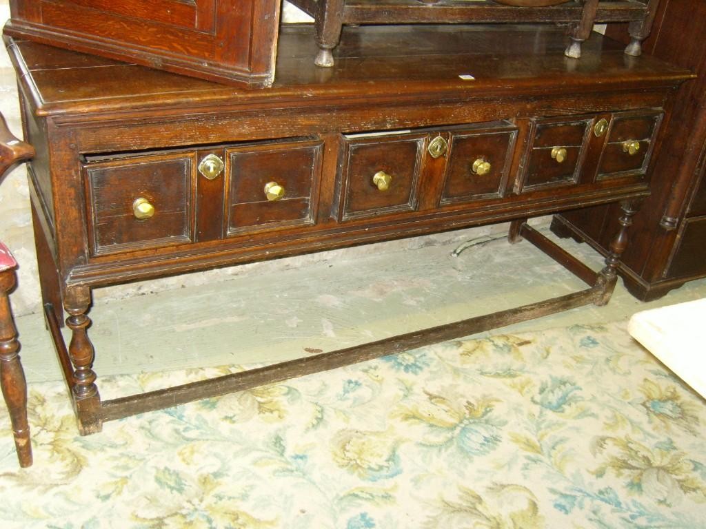 Appraisal: An th century oak dresser base fitted with three panelled