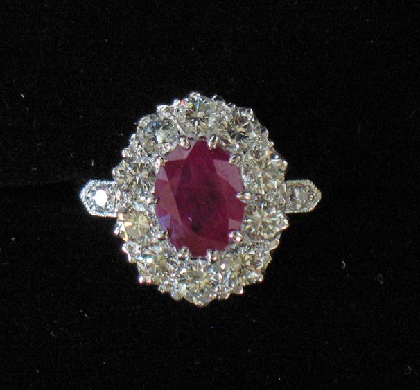 Appraisal: A RUBY AND DIAMOND CLUSTER RING the central oval cushion-cut