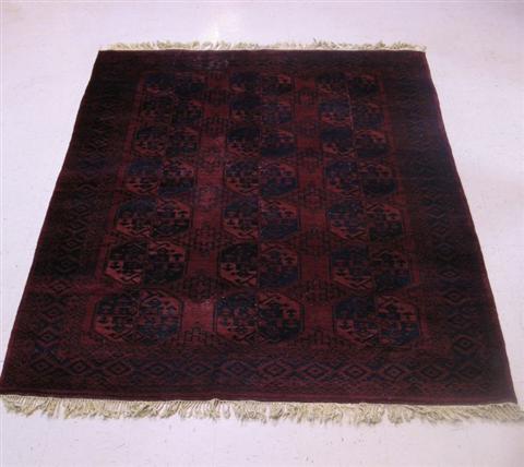 Appraisal: ORIENTAL RUG Red ground with navy decorative elements - w