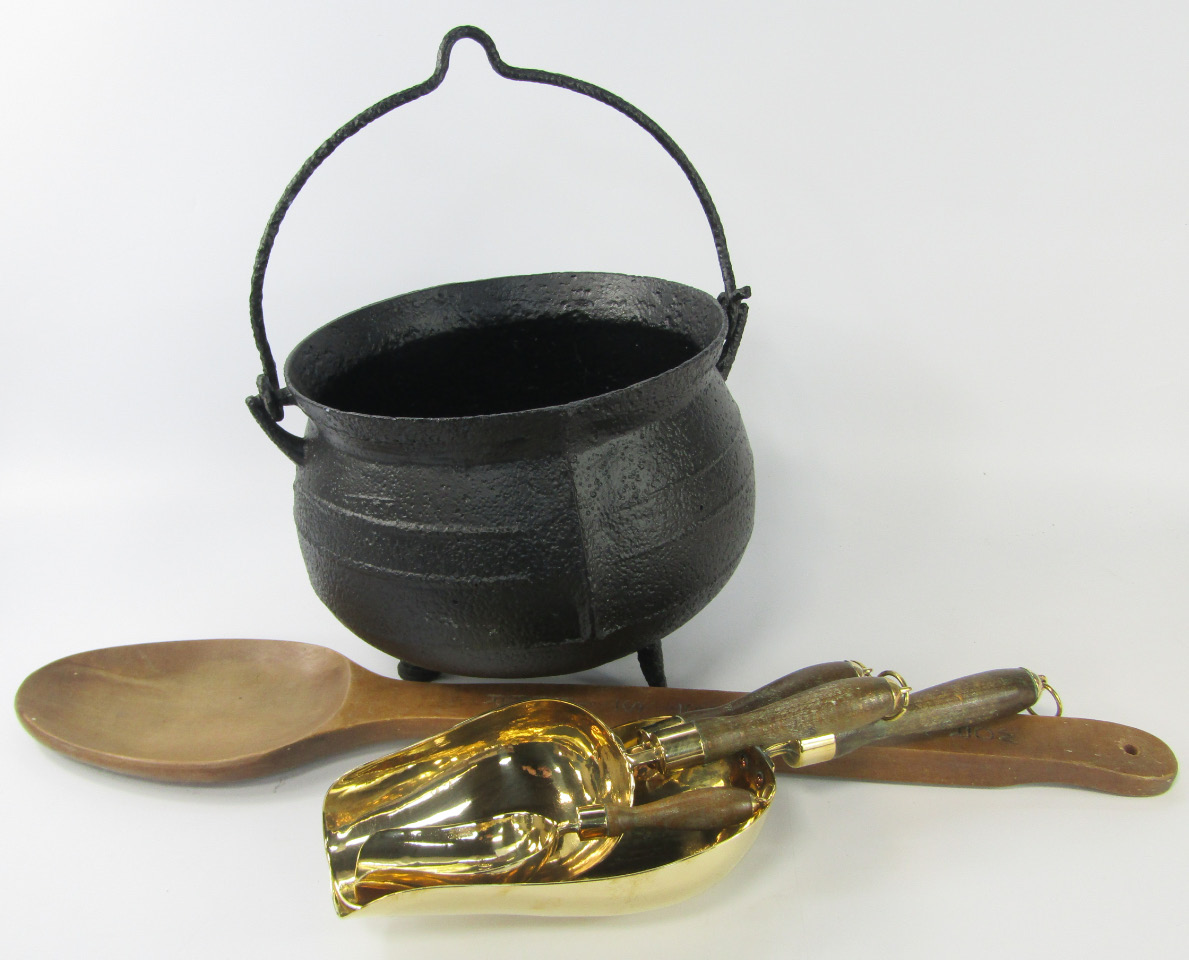 Appraisal: A cast iron cauldron four graduated brass scoops with wooden