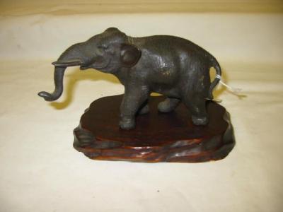 Appraisal: A JAPANESE BRONZE FIGURE modelled as an elephant raised on