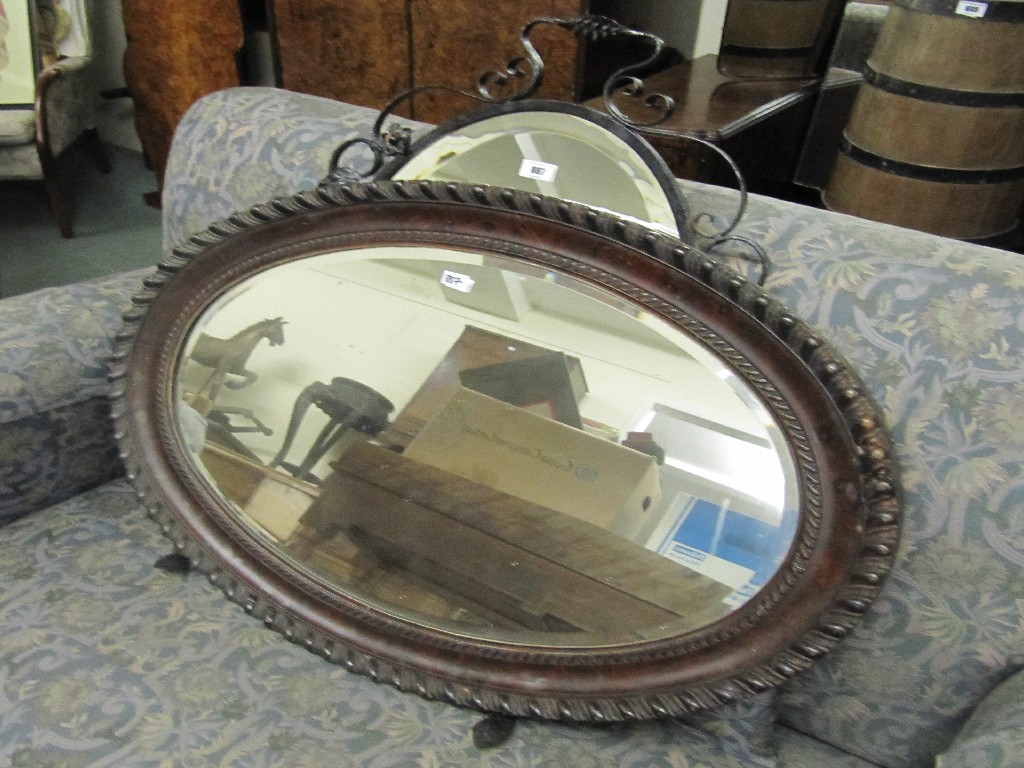 Appraisal: Mahogany oval wall mirror and a mirrored firescreen