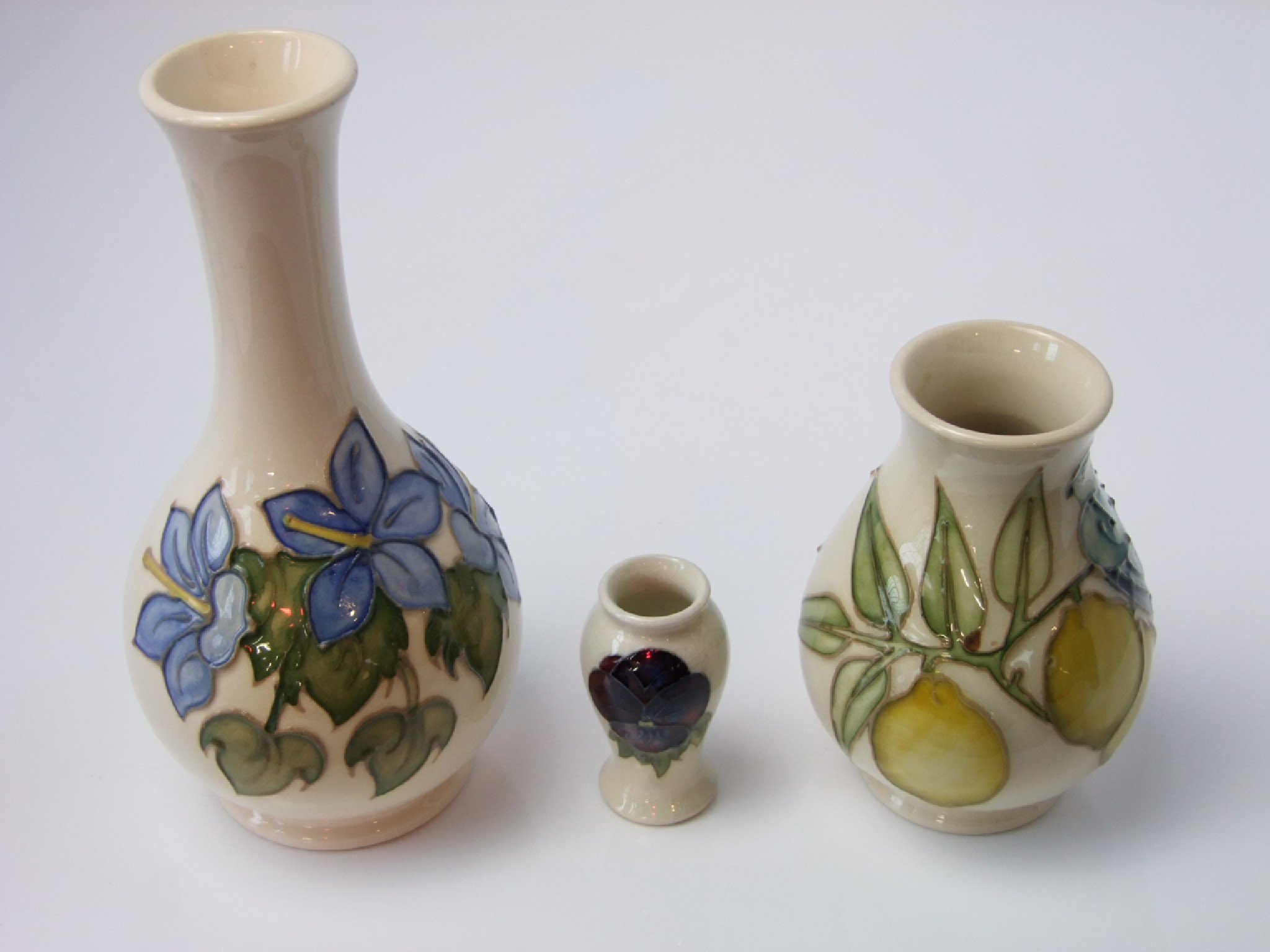 Appraisal: A collection of cream ground Moorcroft wares comprising a vase