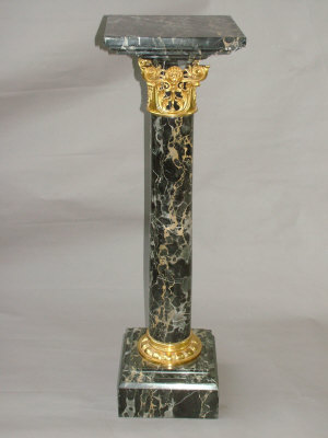 Appraisal: A pair of th century Continental variegated black marble pedestals