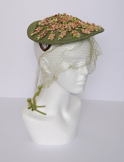 Appraisal: A green woven s hat elaborate pale pink faux flower