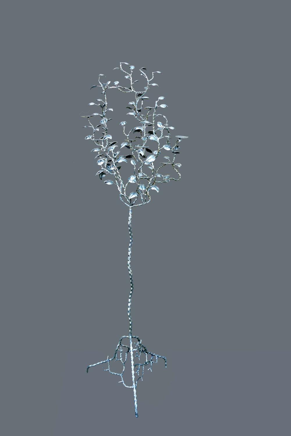 Appraisal: CONTEMPORARY SILVERED-IRON TREE-FORM CANDLE STANDThe branch-like tripod base supporting a