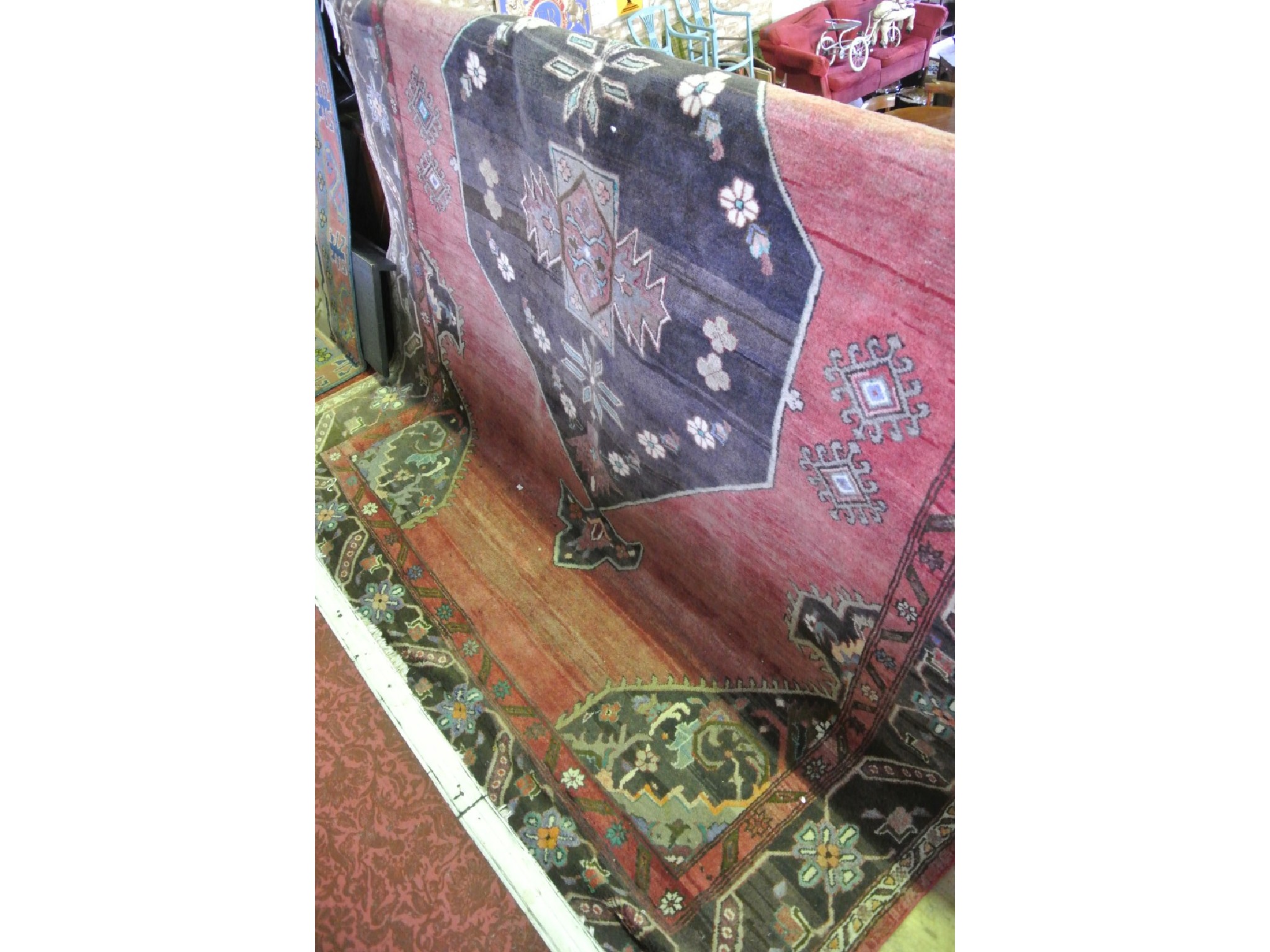 Appraisal: A large Eastern wool carpet the central medallion in a