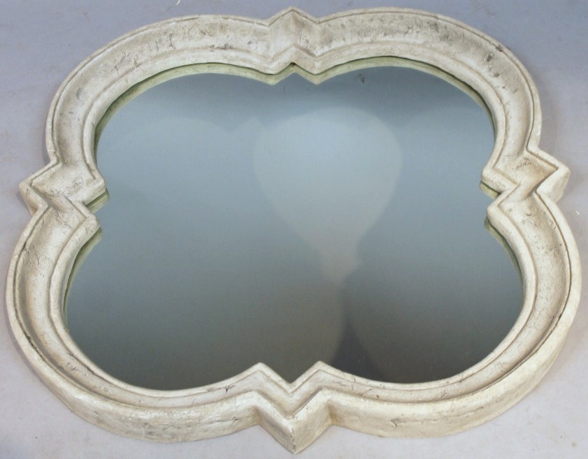 Appraisal: A thC floral designed carved stone wall mirror with an