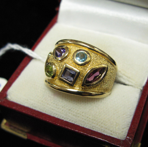 Appraisal: COLOR GEMSTONE AND FOURTEEN KARAT GOLD RING The wide band