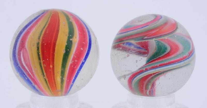 Appraisal: Lot Of Naked Ribbon Swirl Marbles The smaller is a