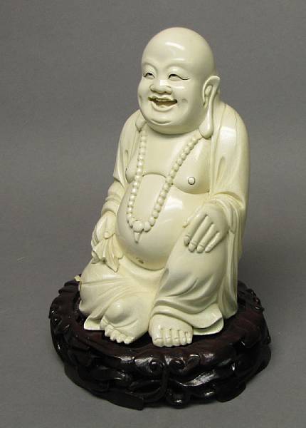 Appraisal: An ivory seated figure of Budai The laughing god of