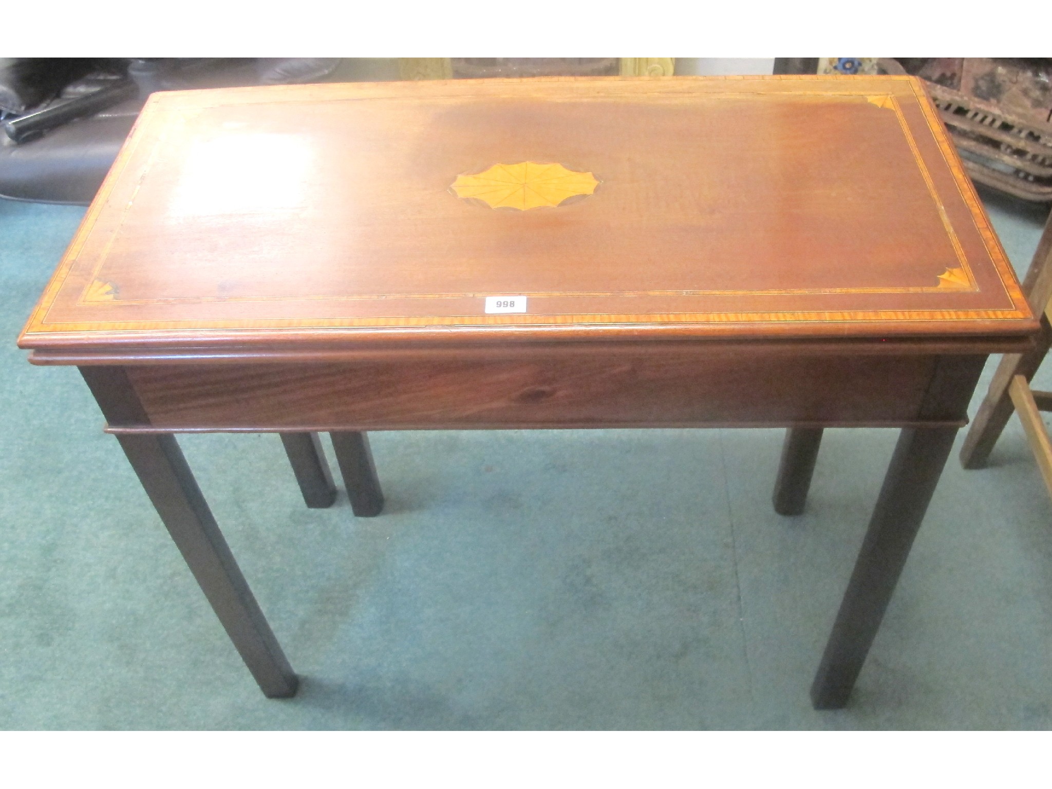 Appraisal: A mahogany inlaid fold-over card table