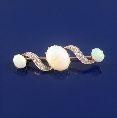 Appraisal: An opal and diamond brooch set with three graduated oval