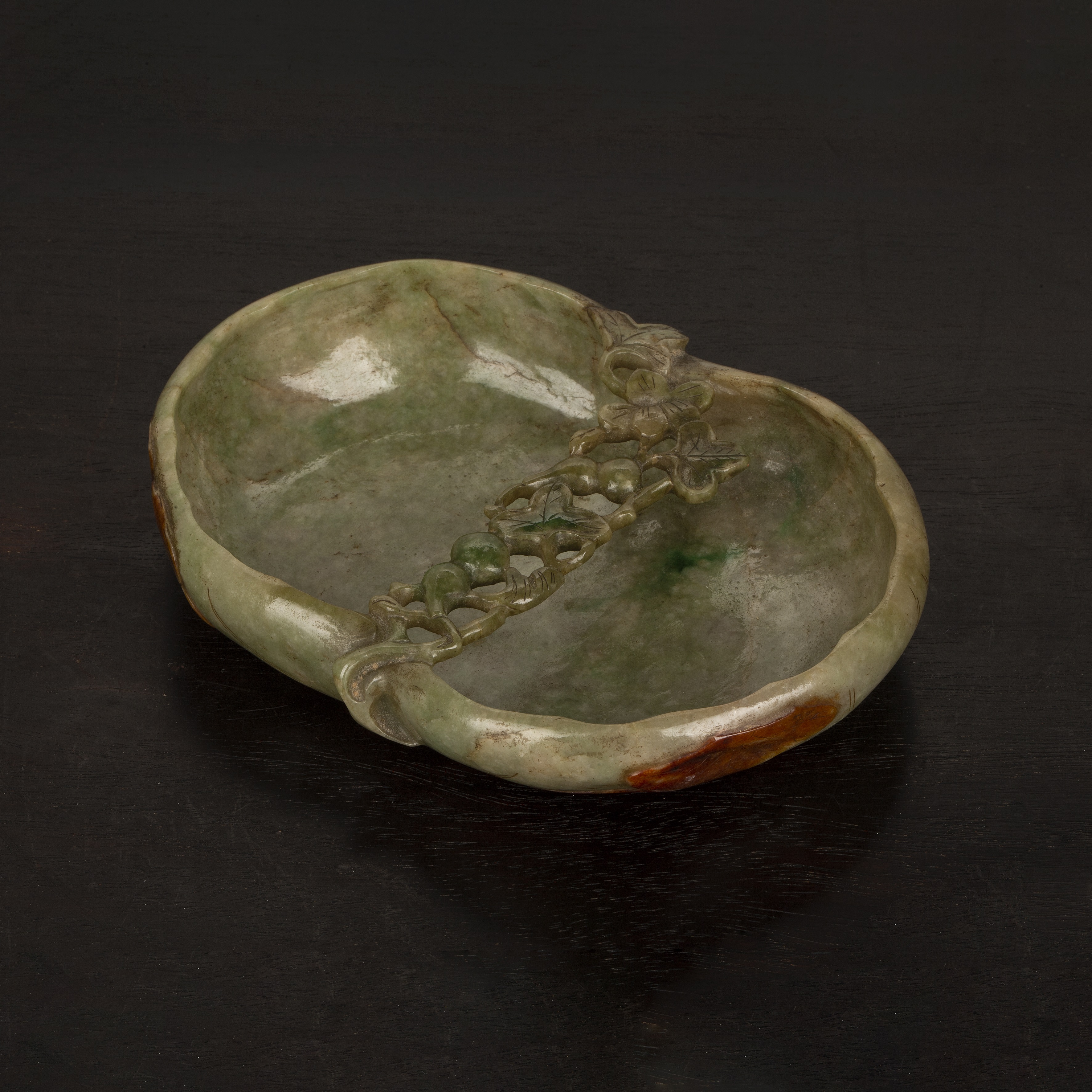 Appraisal: Mottled green jade shallow dishChinese th Century shaped as a