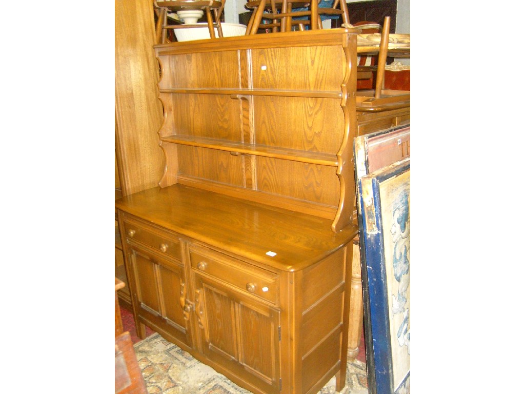 Appraisal: An Ercol elm cottage dresser the base enclosed by a