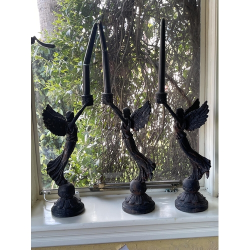 Appraisal: Set of three cast iron winged Victory candlesticks