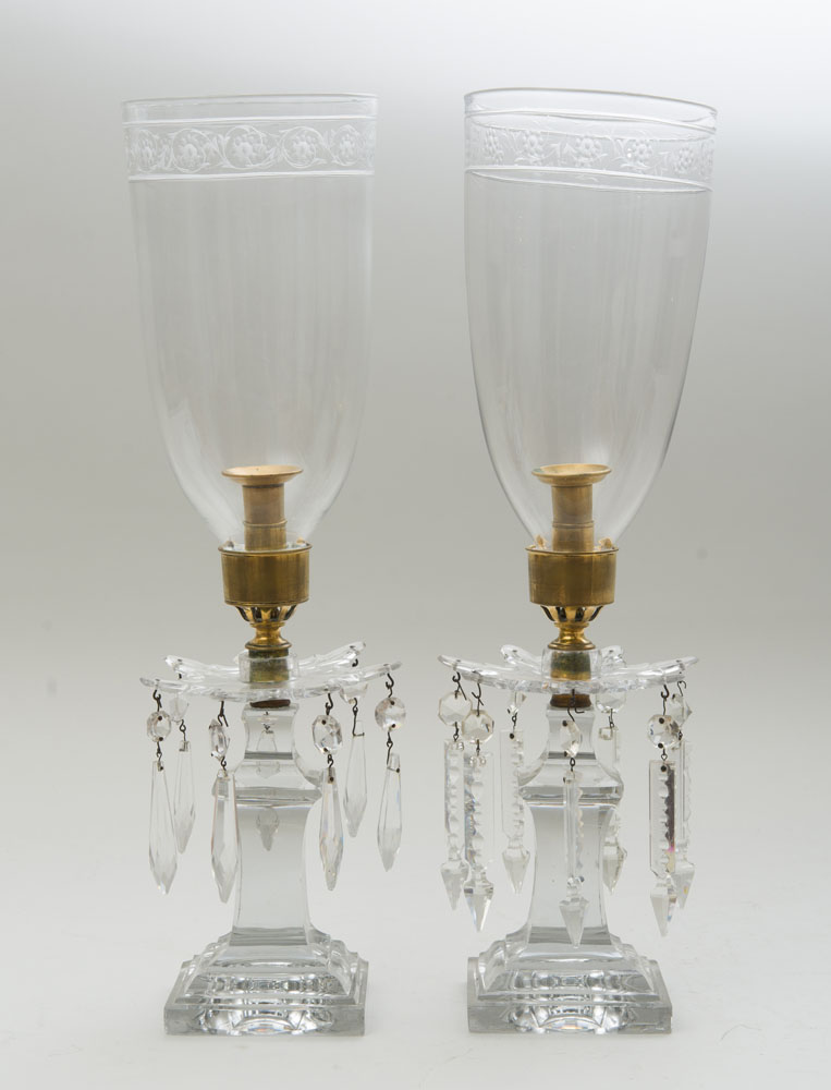 Appraisal: PAIR OF ENGLISH BRASS-MOUNTED GLASS CANDLESTICKS With etched glass hurricane