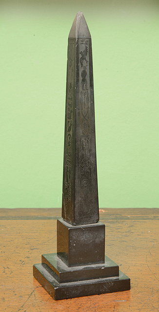 Appraisal: A CARVED BLACK SLATE MODEL of an obelisk on a