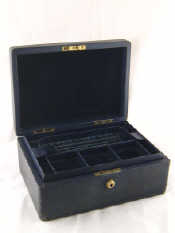 Appraisal: A velvet lined leather cased jewellery box with lift out