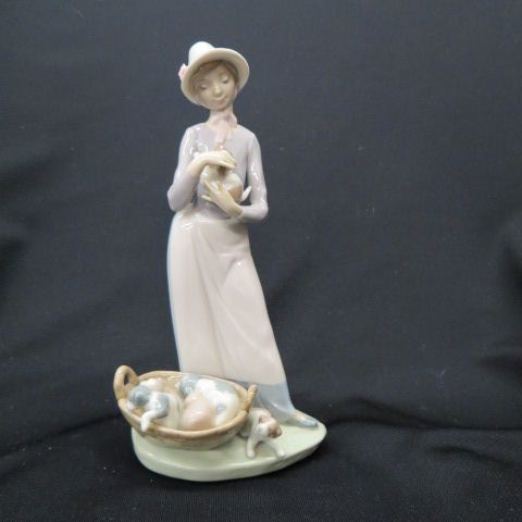 Appraisal: Lladro Porcelain Figurine Girl with Puppies holding one with a