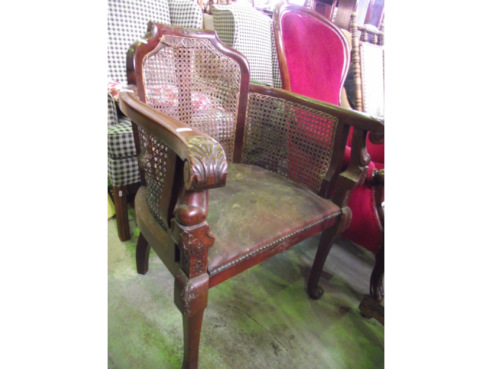 Appraisal: An Edwardian bergere armchair with cane panelled backs and side