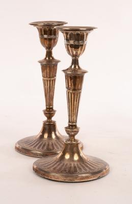 Appraisal: A pair of silver candlesticks HE Co Sheffield the tapered