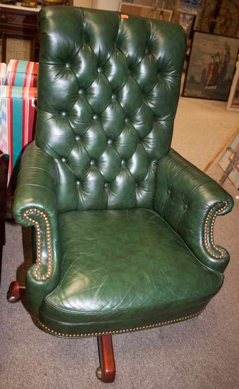 Appraisal: Cherrywood leather button-back upholstered swivel armchair Estimate - No condition