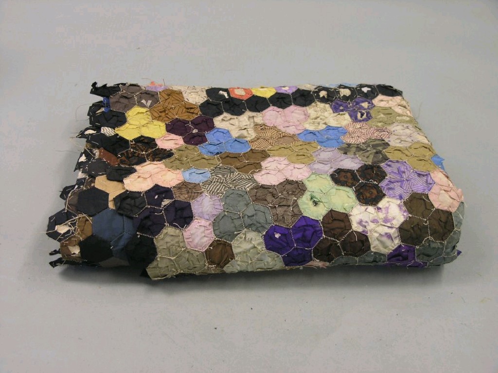 Appraisal: A Victorian patchwork quilt numerous multi-coloured hexagons newspaper foundation dated