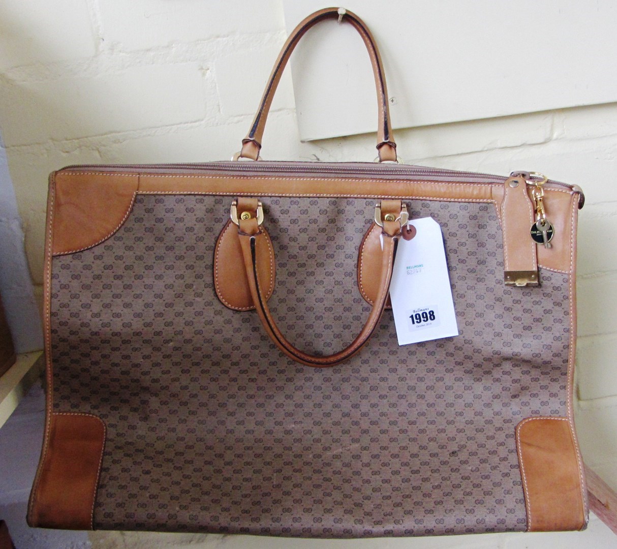 Appraisal: A leather and canvas Gucci bag with a key 's