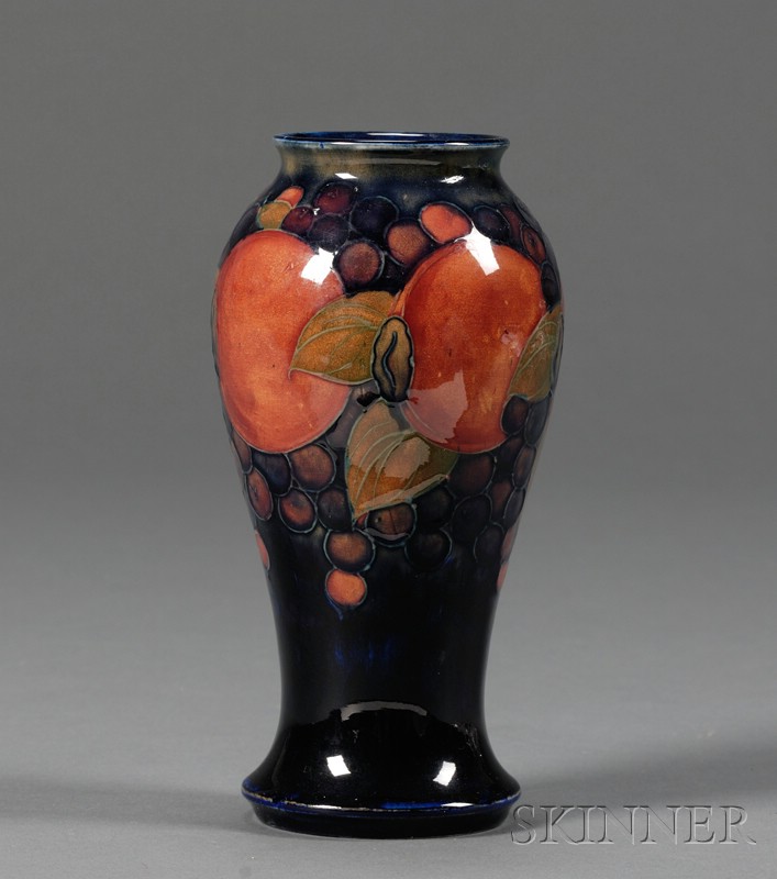 Appraisal: Moorcroft Pottery Pomegranate Vase England c dark blue enamel ground