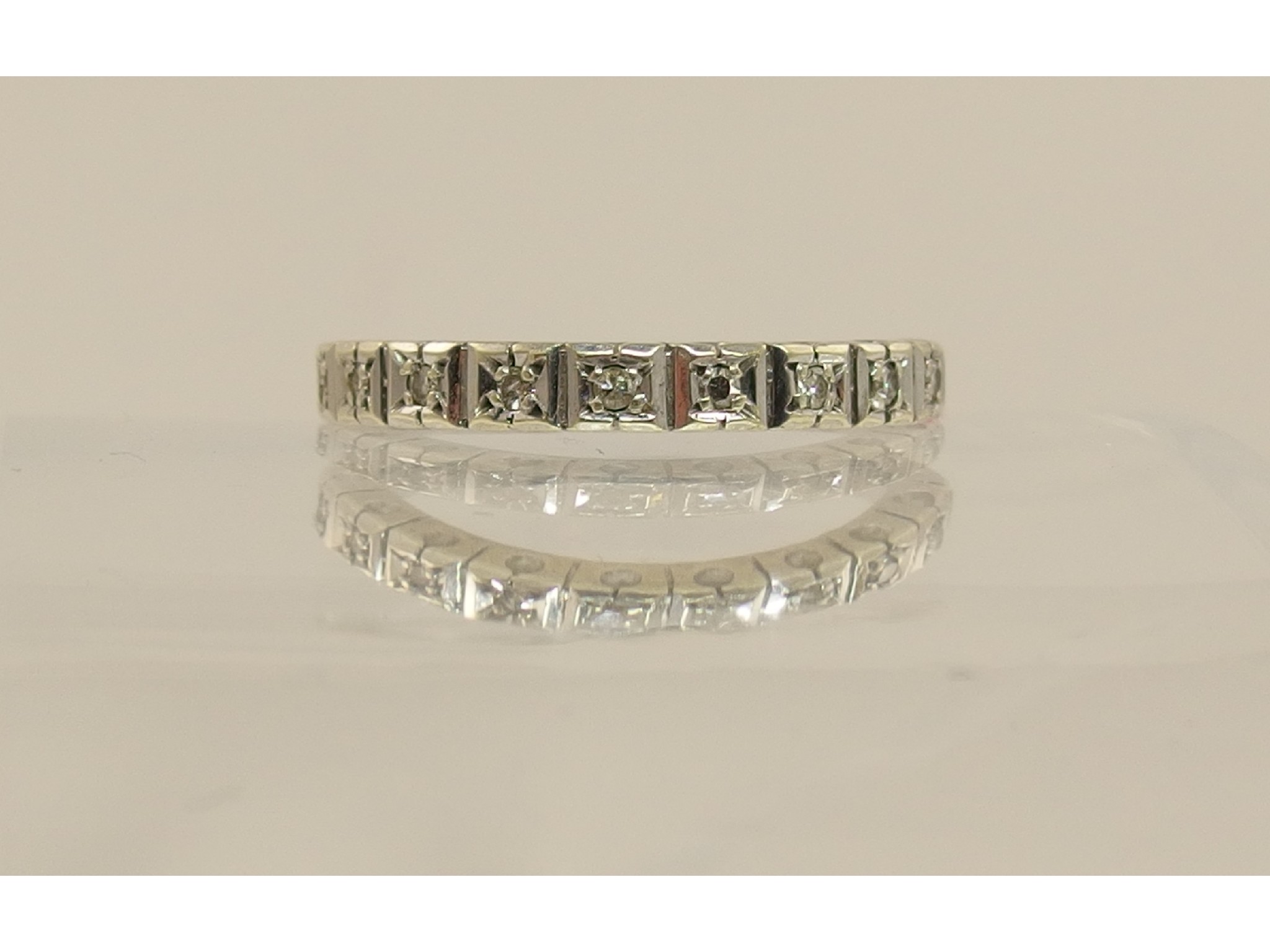 Appraisal: A white metal diamond half eternity ring