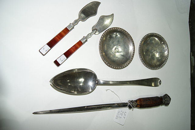 Appraisal: A CONTINENTAL WHITE METAL BASTING SPOON together with a steel